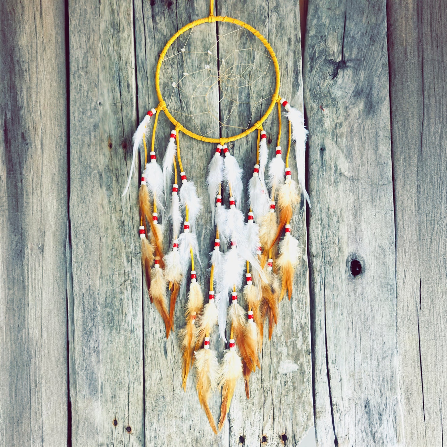 Handmade dreamcatcher with natural feathers