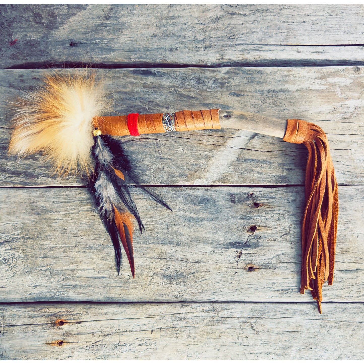 A handcrafted Native talking stick carrying the spirit of transformation and sacred fire.