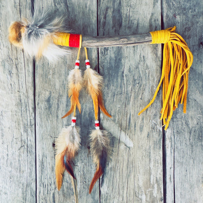 talking stick, yellow leather, tan fox fur, red fabric, white and red beads