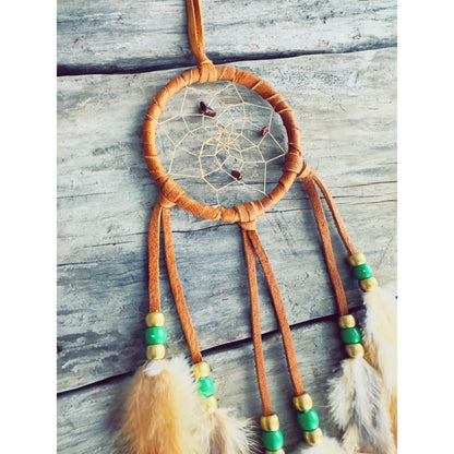 Boho-style Native dreamcatcher handmade with beads, feathers, and natural fibers.
