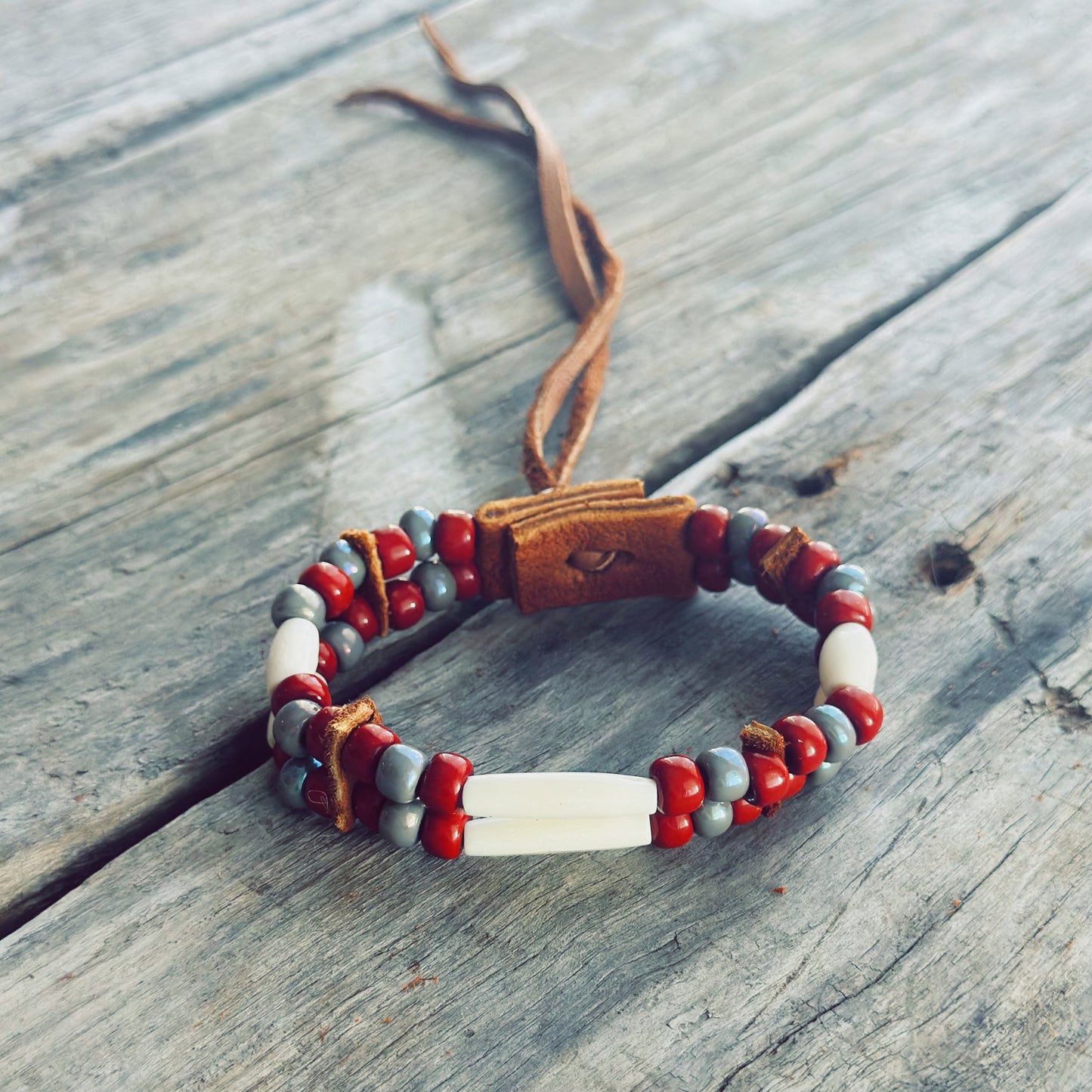 Handmade bone and earth tone glass bead bracelet with genuine moose leather, grounding Indigenous jewelry