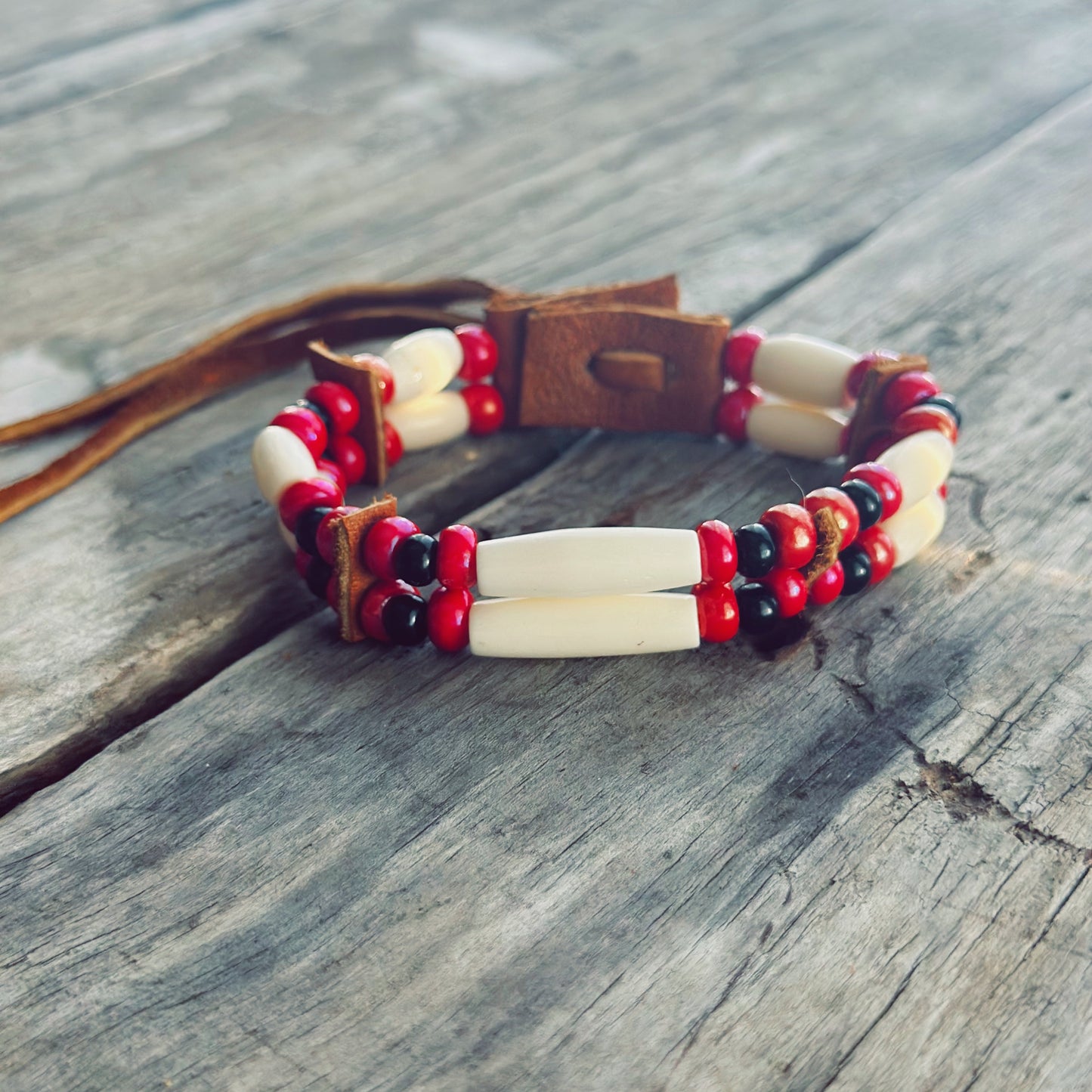 Handmade bone and red glass bead bracelet with genuine moose leather, strength inspired Indigenous jewelry
