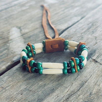 Handmade bone and green glass bead bracelet with genuine moose leather, grounding Indigenous jewelry
