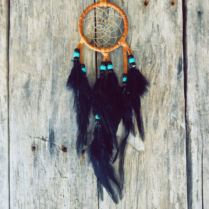 Handmade dreamcatcher with feathers and leather