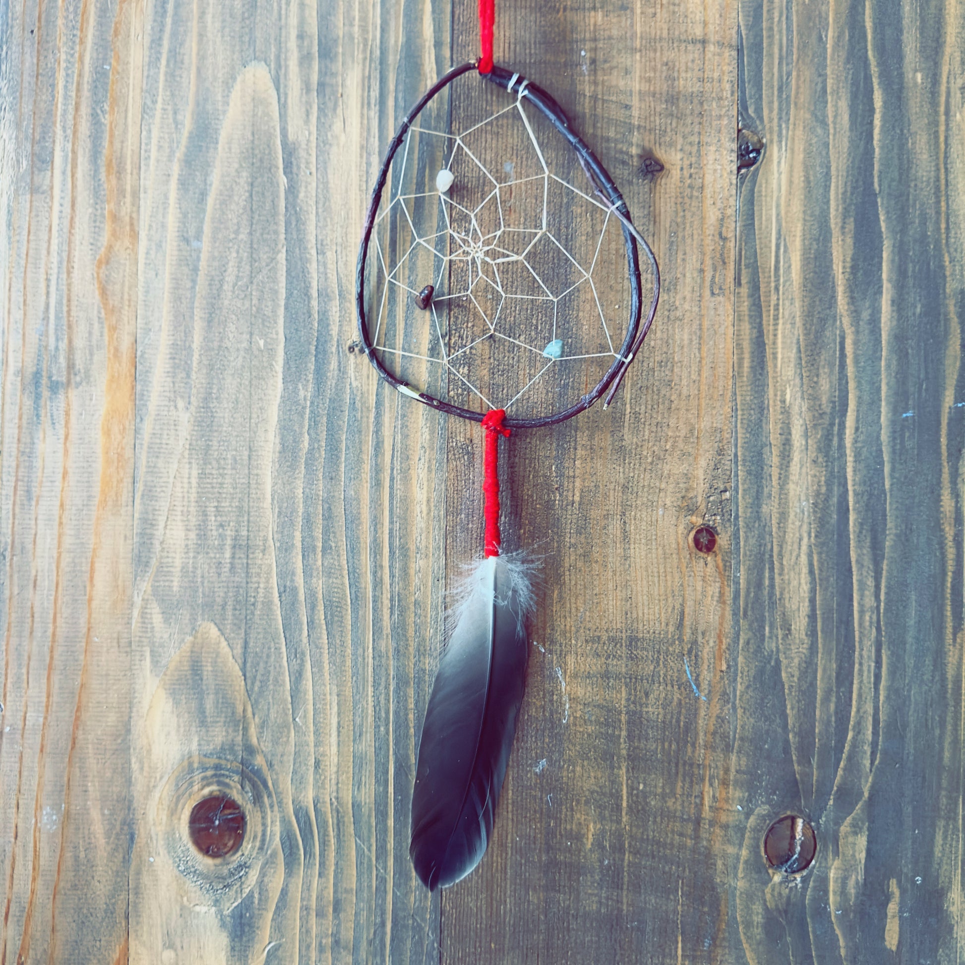 Capteur de rêves artisanal avec plumes naturelles, symbole de protection douce et équilibre émotionnel