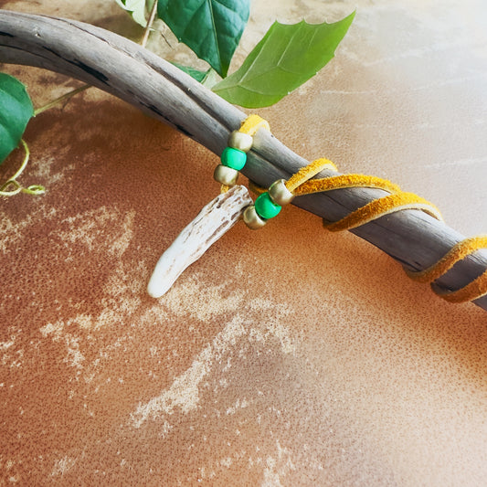 Handcrafted Indigenous necklace made of natural deer antler and moose leather