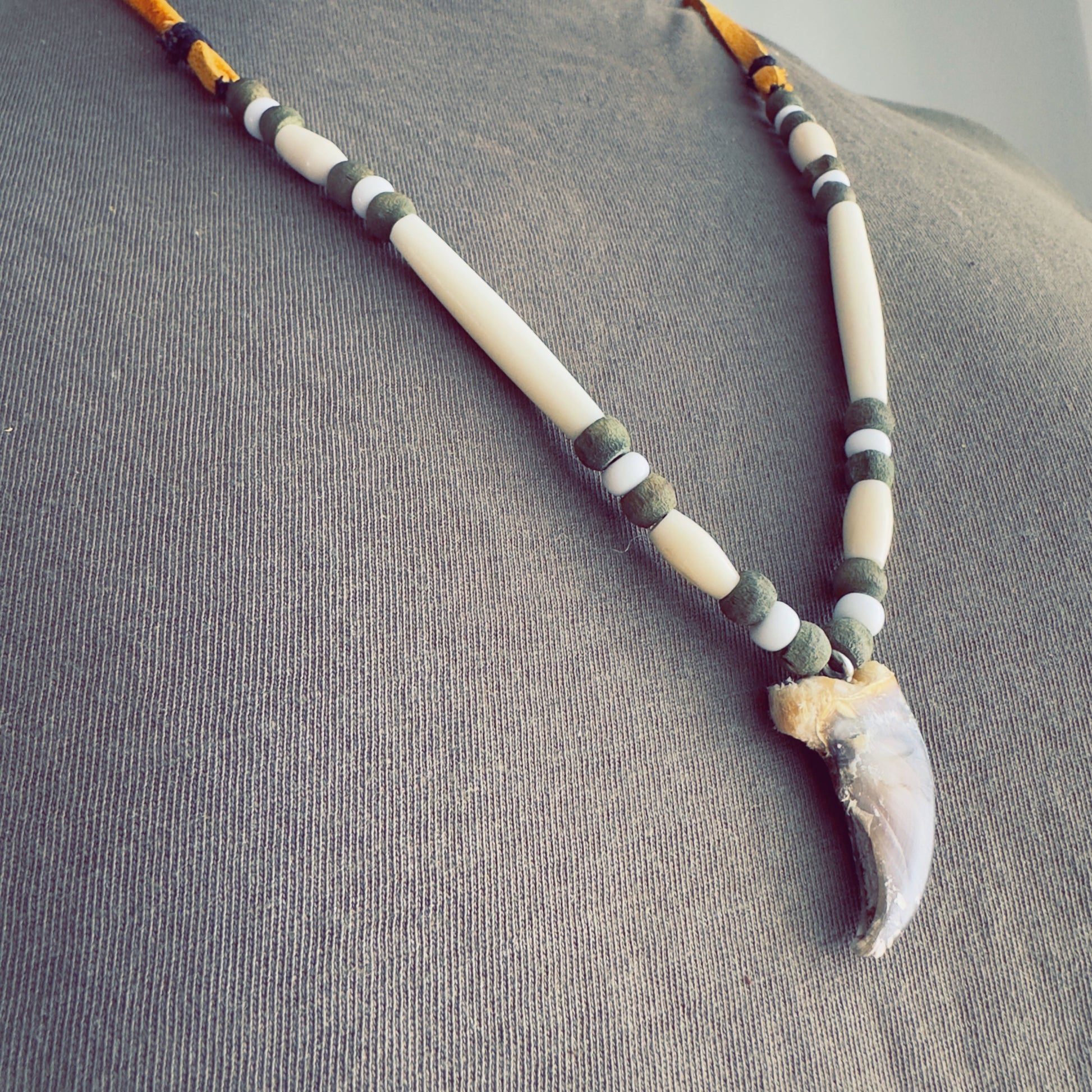 ecklace with bear-inspired pendant and natural earth tones