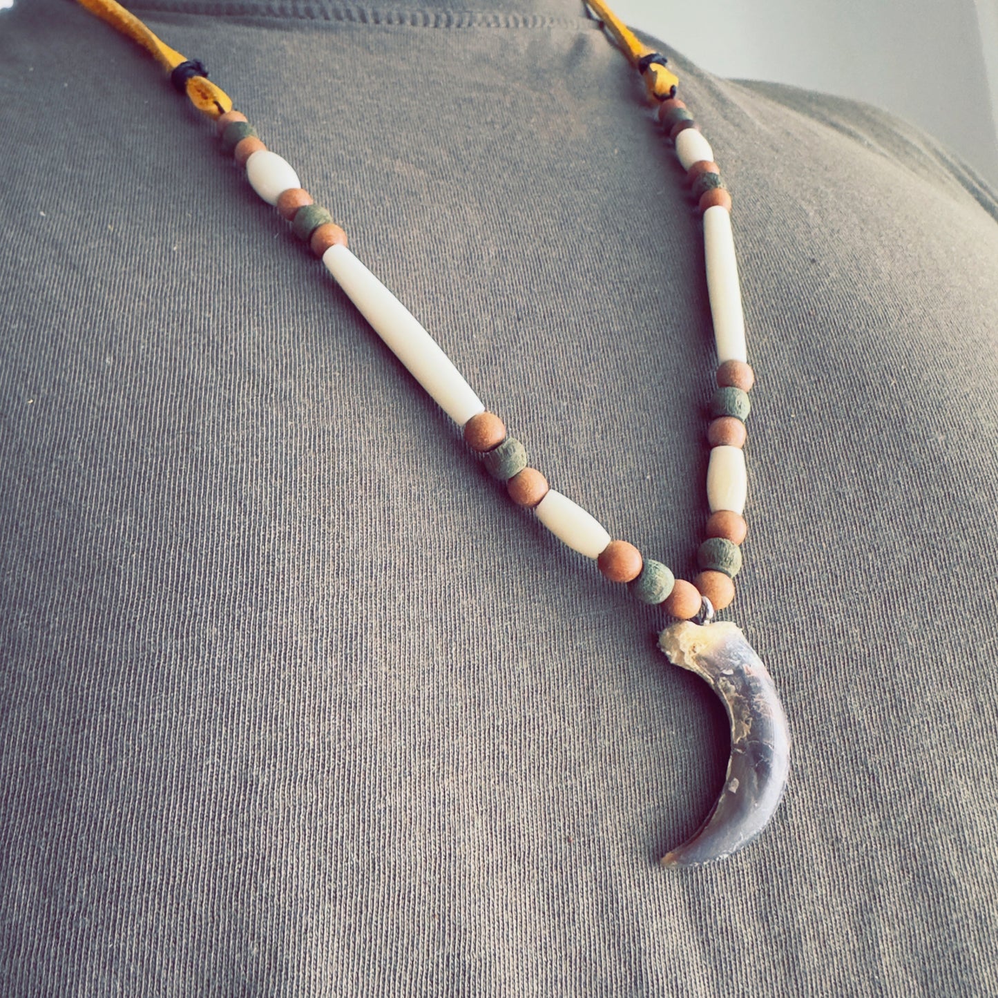 Wolf-inspired talisman necklace with natural beadwork
