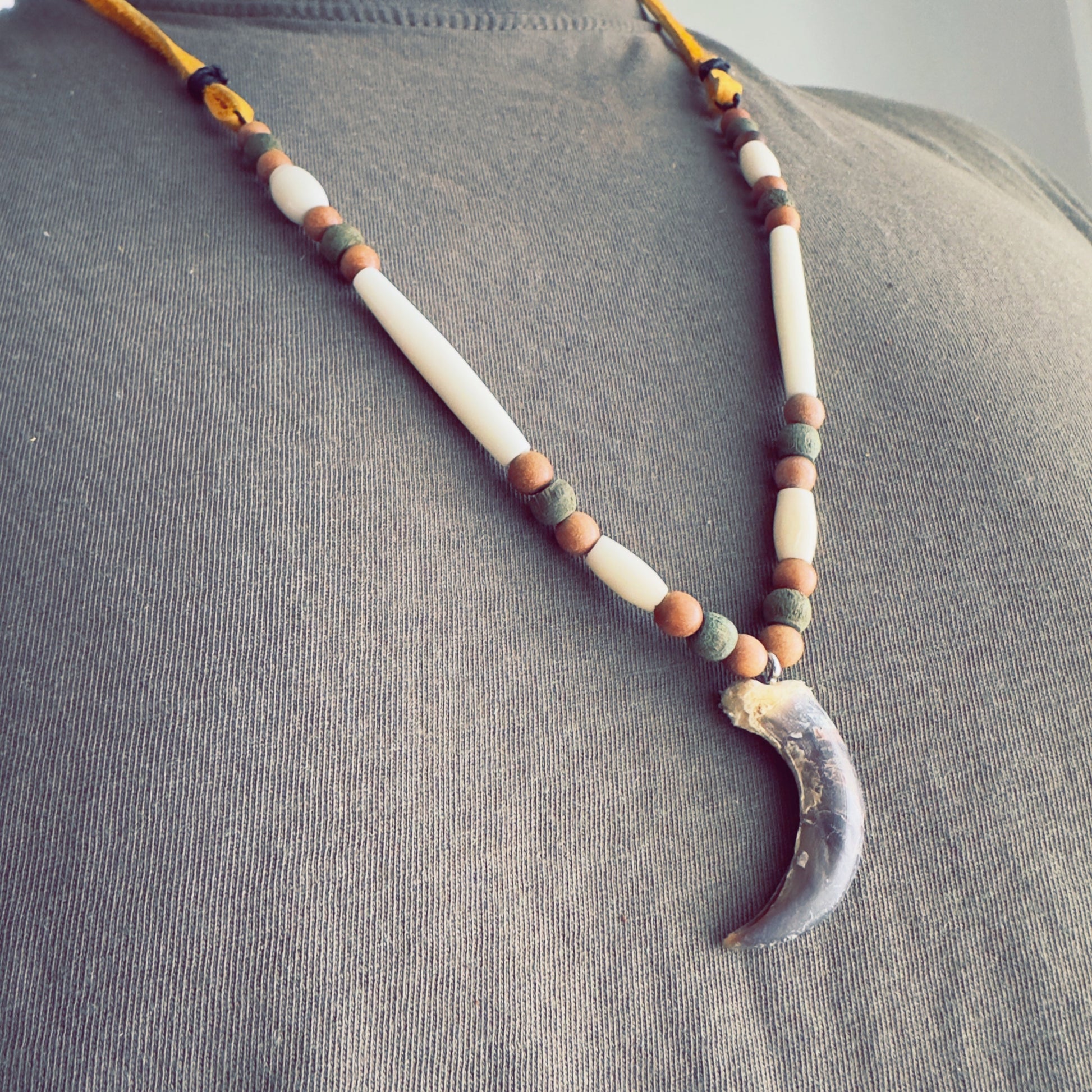 Wolf-inspired talisman necklace with natural beadwork