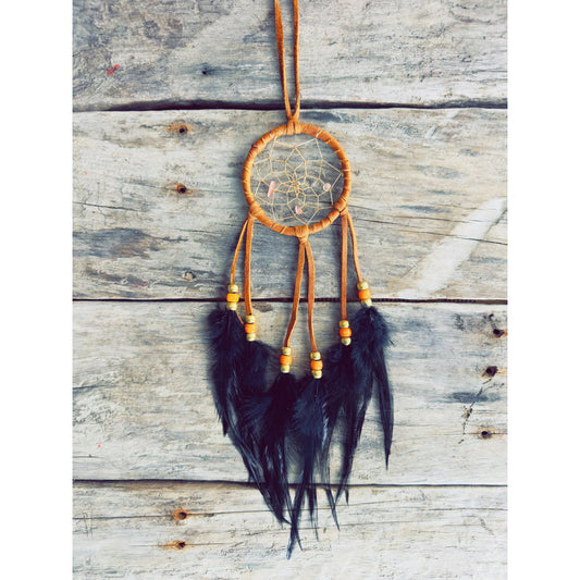 Handcrafted dreamcatcher with brown natural feathers and warm earthy tones, forest-inspired spiritual piece