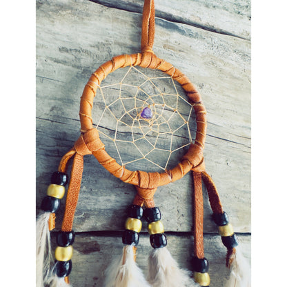 Totem animal dreamcatcher connecting the wearer with spirit guides and animal symbolism in Native spirituality.