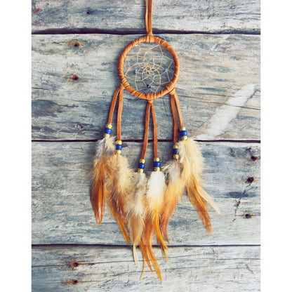 Handcrafted dreamcatcher decorated with natural feathers and traditional materials.