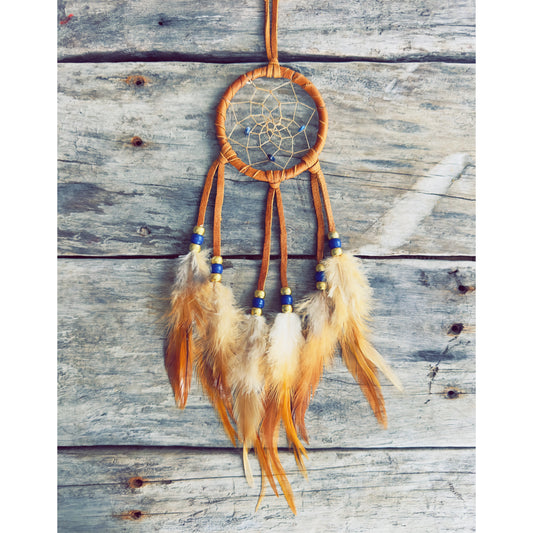 Handcrafted dreamcatcher decorated with natural feathers and traditional materials.