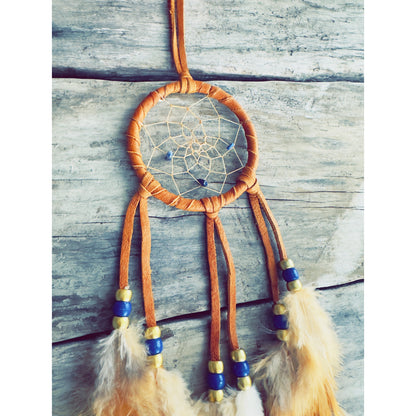 Native-inspired dreamcatcher used as wall art, made with leather and real feathers.