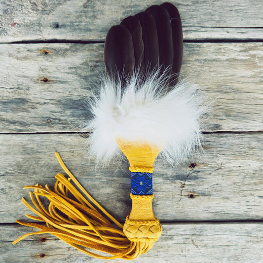 Handmade Indigenous smudging fan in moose leather with white wolf fur and natural feathers