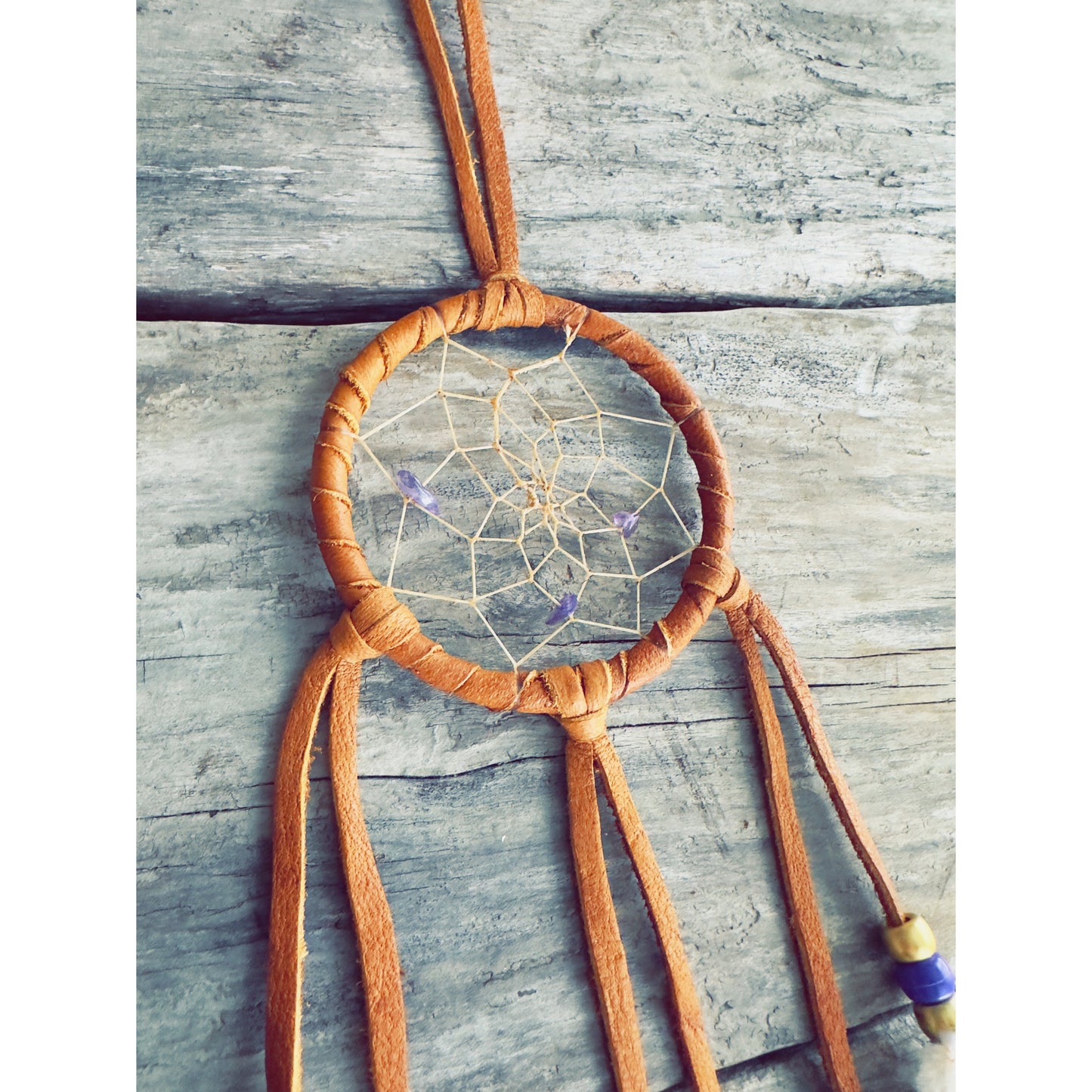Traditional Native-inspired dreamcatcher made with natural elements and symbolic design.